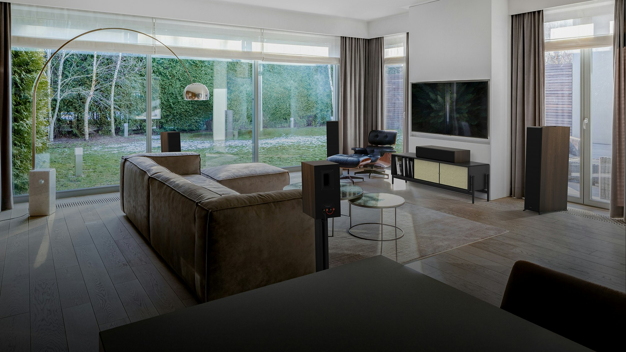 Reference Premiere II Series Home Theater Speakers with a walnut finish in a living room setting with brown furniture